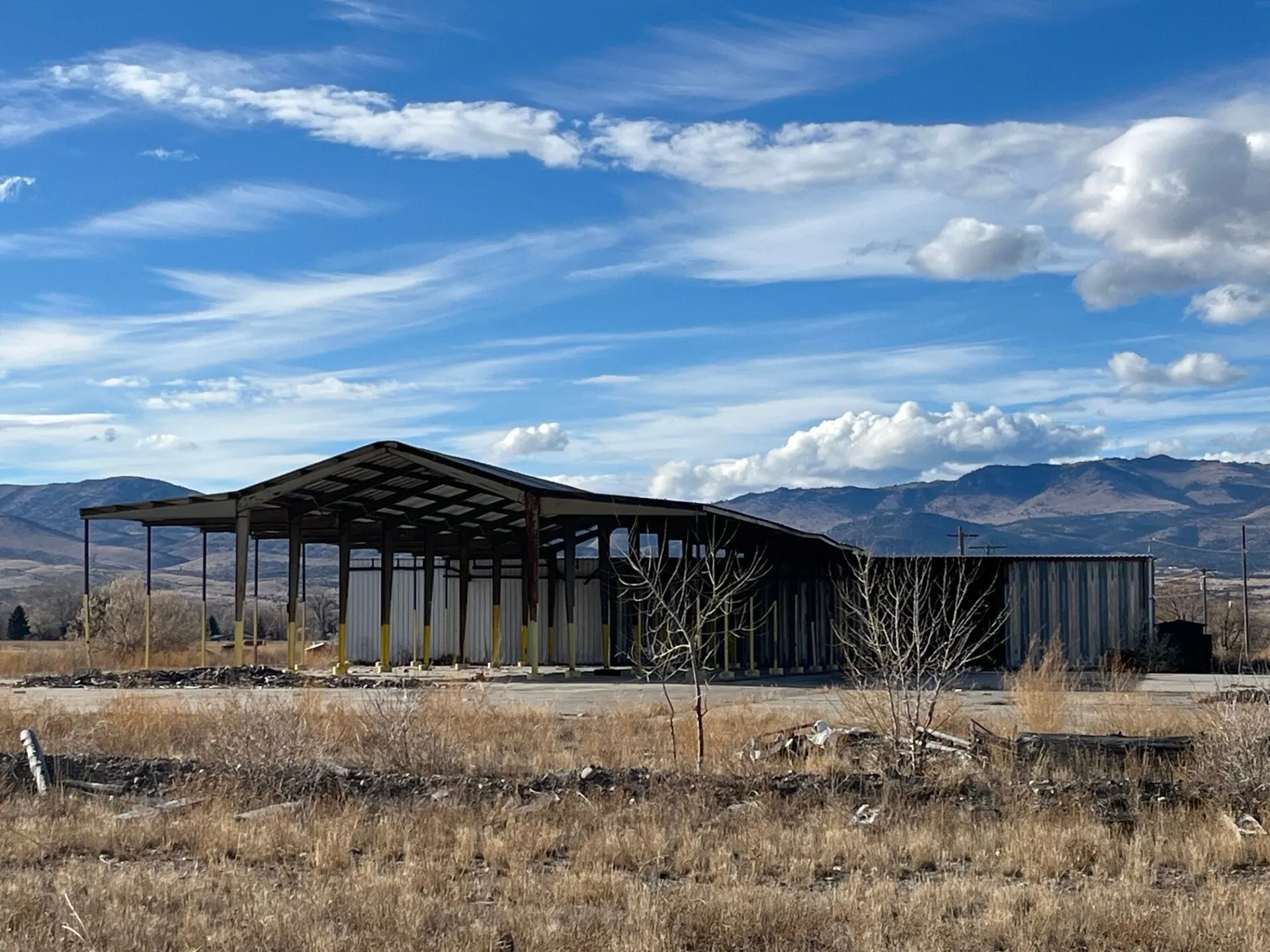 Open-sided steel pavilion on the campus with mountains behind